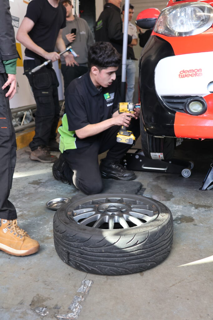 ESC Motorsport Student changing a tire during the Pit Stop Challenge