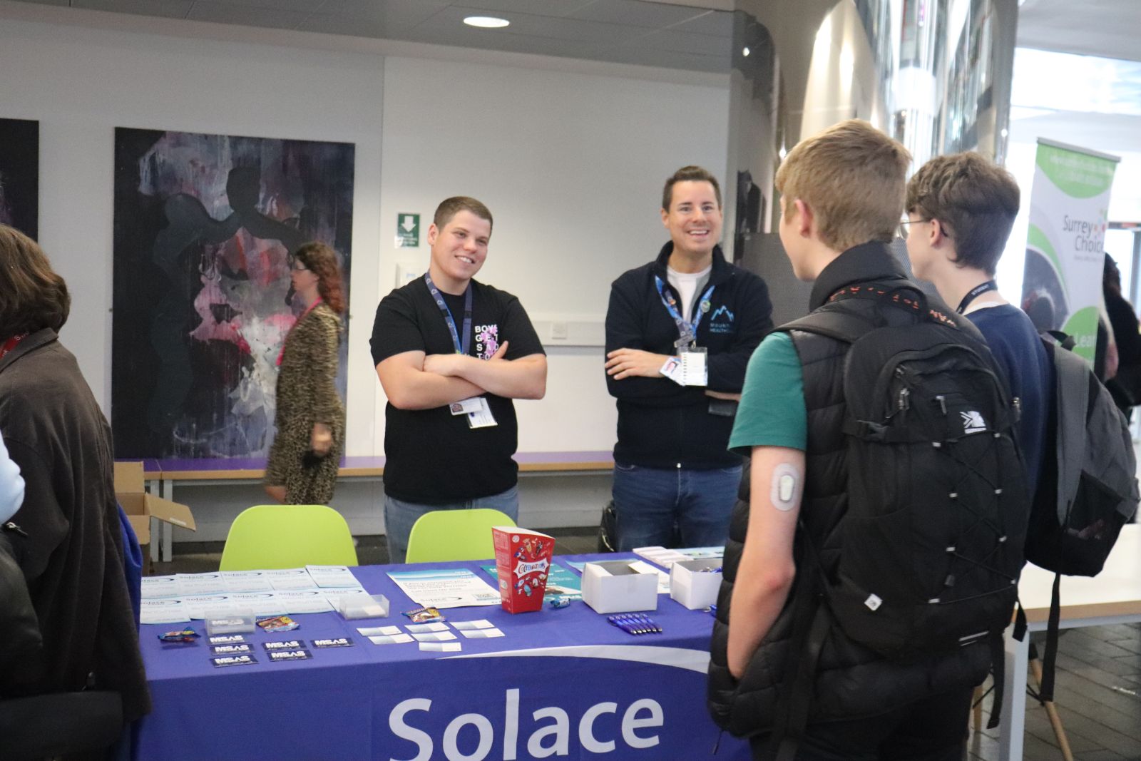 Two students speaking with Solace Representatives